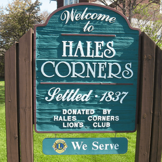 A sign board saying welcome to Hales Corners.